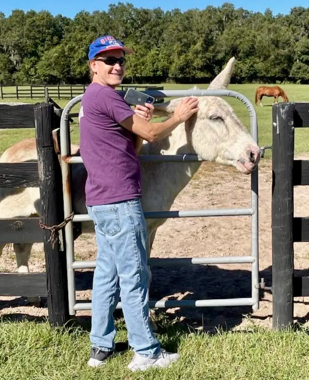 Harris Max with a cow at an animal sanctuary