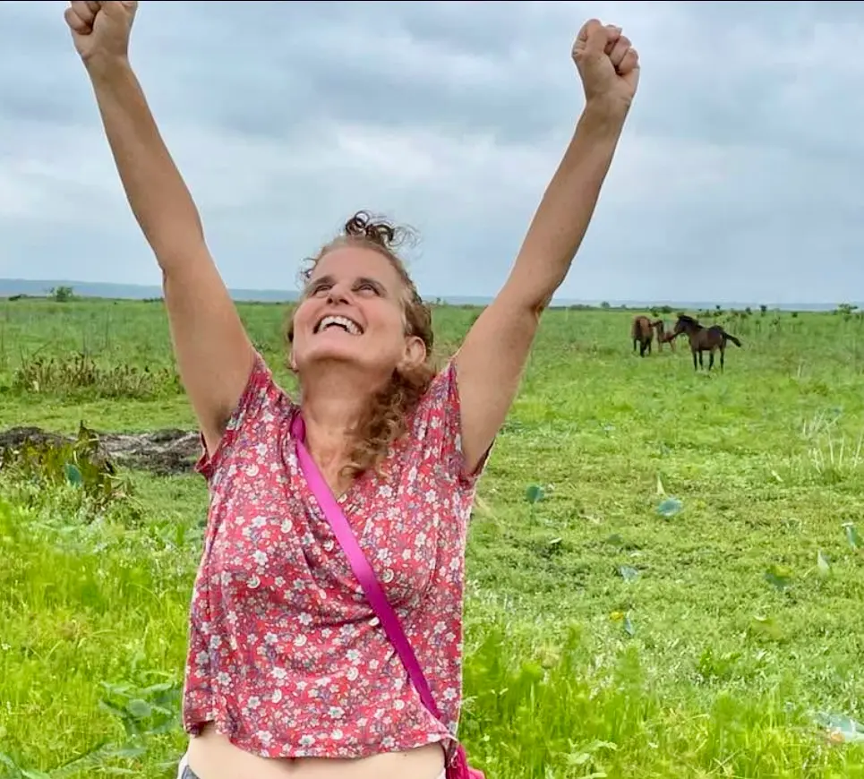 Lynn Max with a cow at an animal sanctuary